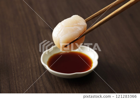 Dip scallop sashimi in soy sauce 121283366