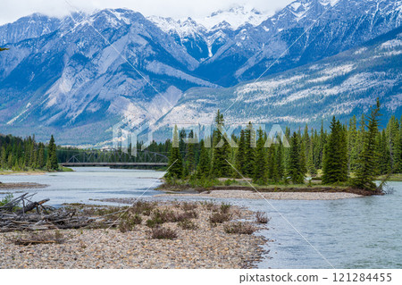 Jasper National Park summer landscape. Athabasca River, snow-capped mountains in the background. Alberta, Canada. Canadian Rockies. Jasper National Park summer landscape. Athabasca River, snow-capped mountains in the background. Alberta, Canada. Canadian Rockies. 121284455