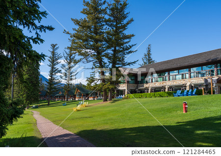 Alberta, Canada - June 8 2021 : Fairmont Jasper Park Lodge Resort cabins. Adirondack chairs on the lakeside of Beauvert Lake, Lac Beauvert Trail. 121284465