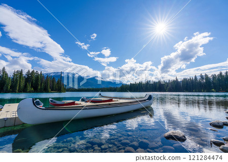 White Canoe on dock at Beauvert Lake (Lac Beauvert). Jasper National Park summer landscape. Alberta, Canada. 121284474
