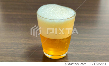 金色的生啤酒和細小的氣泡倒入玻璃杯中 121285451