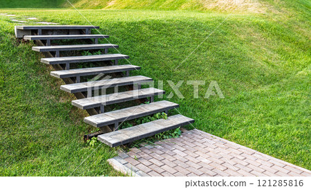 Outdoor staircase on green grassy lawn slope Outdoor staircase on green grassy lawn slope 121285816