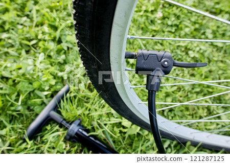 Attached multi valve head for all types of valves to Schrader valve on bicycle wheel. Attached multi valve head for all types of valves to Schrader valve on bicycle wheel. 121287125