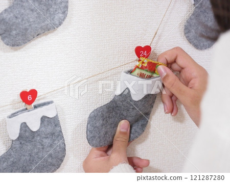 Child looking at advent calendar Child looking at advent calendar 121287280