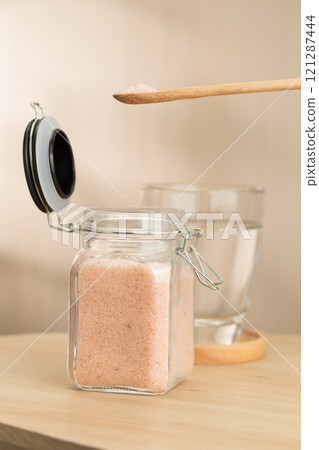 A jar of Himalayan salt sits on a table. 121287444