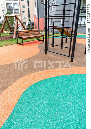 Colorful playground with benches and equipment in urban setting Colorful playground with benches and equipment in urban setting 121287750