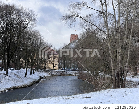 View of the Upper Castle Gediminas Tower in winter on the snow covered hill from from Sventaragis valley park, Vilnius, Lithuania View of the Upper Castle Gediminas Tower in winter on the snow covered hill from from Sventaragis valley park, Vilnius, Lithuania 121289029