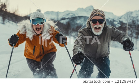 Active couple skiing downhill, snowy peaks and dynamic winter vibes. Active retirees enjoying life Active couple skiing downhill, snowy peaks and dynamic winter vibes. Active retirees enjoying life 121289417