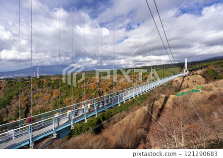 View of the Mishima Skywalk Bridge, the longest foot suspension bridge in Japan, on a sunny day with moving clouds in background View of the Mishima Skywalk Bridge, the longest foot suspension bridge in Japan, on a sunny day with moving clouds in background 121290683