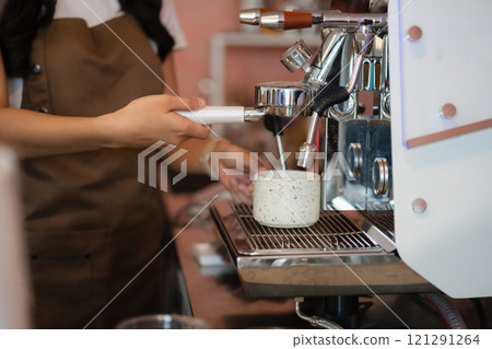 Young barista making coffee, coffee preparation service concept. Young barista making coffee, coffee preparation service concept. 121291264
