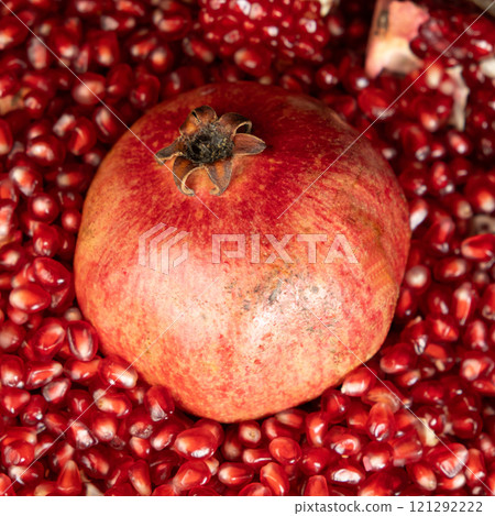 A whole pomegranate and pomegranate grains close-up. 121292222