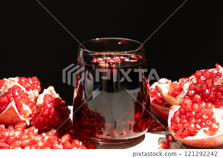 Natural organic pomegranate juice is garnished with pomegranate seeds 121292242