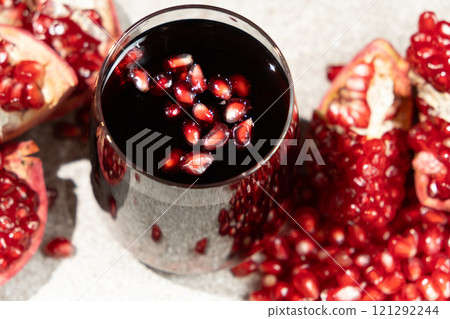 Natural organic pomegranate juice is garnished with pomegranate seeds 121292244