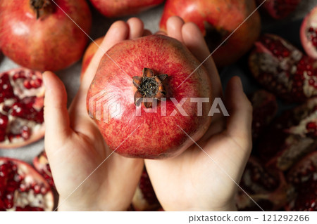 Ripe pomegranate in the hands, the concept of benefits and vitamins. 121292266