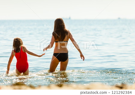 Little girl kid and woman mother in sea water. Fun Little girl kid and woman mother in sea water. Fun 121292384