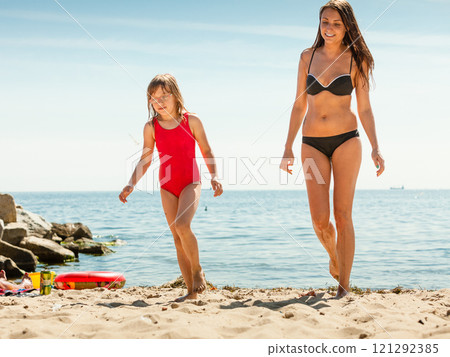 Little girl kid and woman mother on beach. Little girl kid and woman mother on beach. 121292385