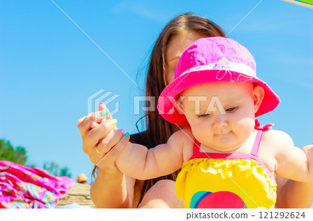 Mother and baby posing in swimsuit 121292624