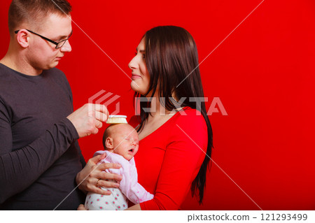 Newborn on mother chest, father brushing baby hair Newborn on mother chest, father brushing baby hair 121293499