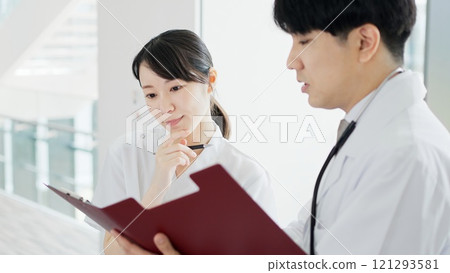 Doctor and nurse discussing medical policy 121293581