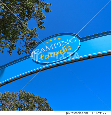 Camping Paradis sign, four stars against a blue sky in Port Grimaud Camping Paradis sign, four stars against a blue sky in Port Grimaud 121294772