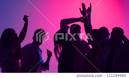 Laughter echoes as friends raise glasses high, celebrating night of connection, rhythm, and shared joy of youth under vibrant lights. 121294980