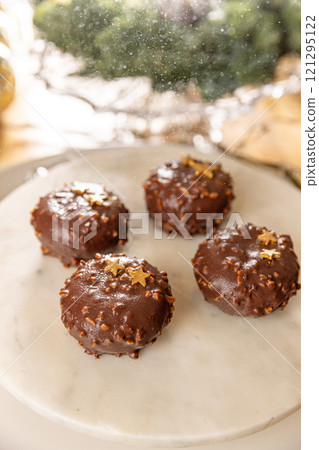 Four chocolate cakes covered with nuts Four chocolate cakes covered with nuts 121295122