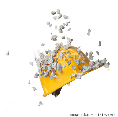 Construction supply equipment rock gravel fall into safety hard yellow hat as accident. Safety Hat protect supply rock gravel from accident falling hit head. White background isolated Construction supply equipment rock gravel fall into safety hard yellow hat as accident. Safety Hat protect supply rock gravel from accident falling hit head. White background isolated 121295268