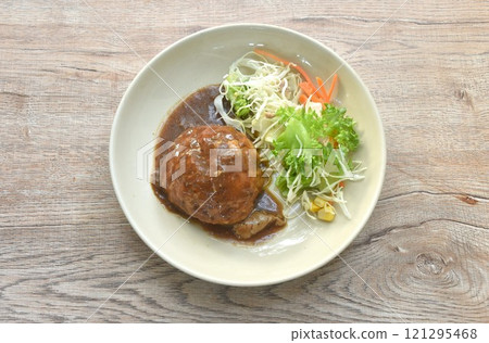 grilled chop pork steak burger dressing gravy sauce with salad on plate grilled chop pork steak burger dressing gravy sauce with salad on plate 121295468