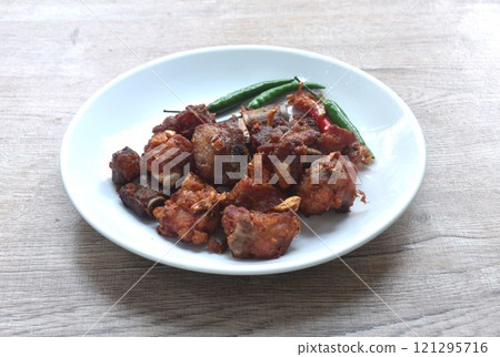 fried fermenting pork bone with garlic eat copple fresh chili on plate fried fermenting pork bone with garlic eat copple fresh chili on plate 121295716