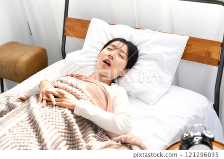 Asian woman snoring on the bed 121296035