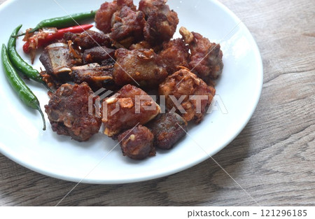 fried fermenting pork bone with garlic eat copple fresh chili on plate 121296185