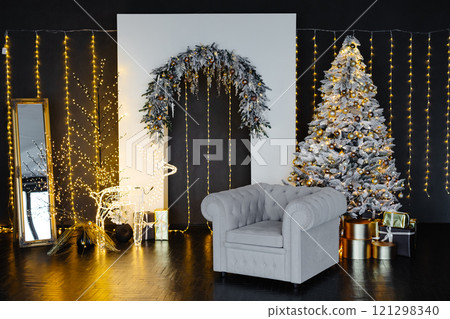 Christmas interior with elegant armchair, decorated tree, and luminous decorations creating festive atmosphere 121298340