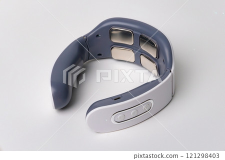 Compact pulse electric smart neck massager on a white background. Copy space 121298403