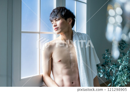 man wiping face with towel 121298905