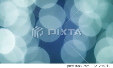 A soft bokeh effect with overlapping circles of light in shades of blue and green, creating a dreamy and abstract visual. 121298910