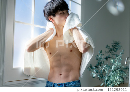 man wiping face with towel 121298911