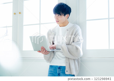 A man looking at a personal computer 121298941