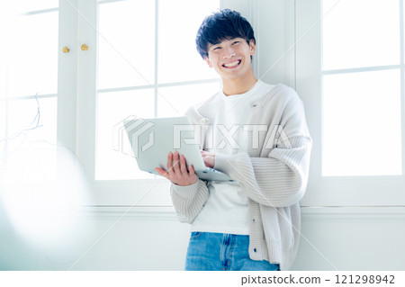 A man looking at a personal computer A man looking at a personal computer 121298942