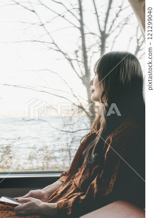 A young woman riding a bus. Photo courtesy of Ugo Kotsu. 121299040
