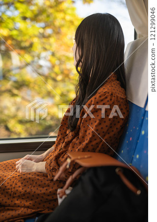 A young woman riding a bus. Photo courtesy of Ugo Kotsu. A young woman riding a bus. Photo courtesy of Ugo Kotsu. 121299046