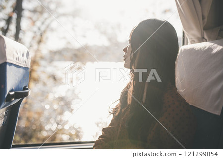 A young woman riding a bus. Photo courtesy of Ugo Kotsu. A young woman riding a bus. Photo courtesy of Ugo Kotsu. 121299054