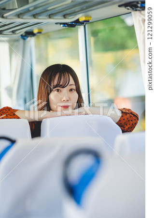 A young woman riding a bus. Photo courtesy of Ugo Kotsu. 121299059