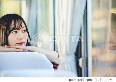 A young woman riding a bus. Photo courtesy of Ugo Kotsu. A young woman riding a bus. Photo courtesy of Ugo Kotsu. 121299060