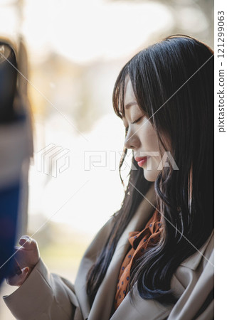 A young woman riding a bus. Photo courtesy of Ugo Kotsu. 121299063