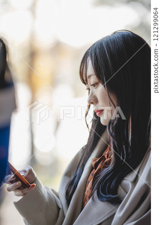 A young woman riding a bus. Photo courtesy of Ugo Kotsu. 121299064