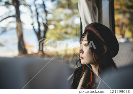 A young woman riding a bus. Photo courtesy of Ugo Kotsu. 121299088