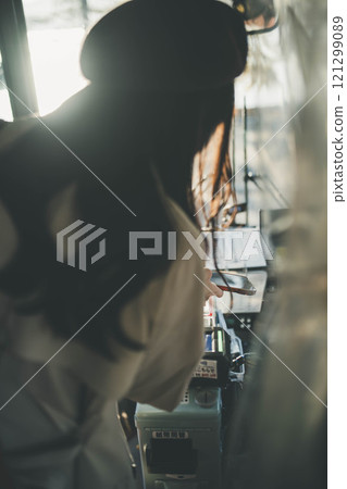 A young woman riding a bus. Photo courtesy of Ugo Kotsu. 121299089
