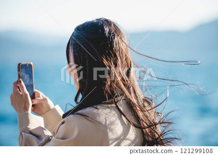 Woman looking at the sea Woman looking at the sea 121299108