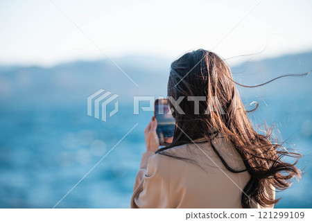 Woman looking at the sea Woman looking at the sea 121299109