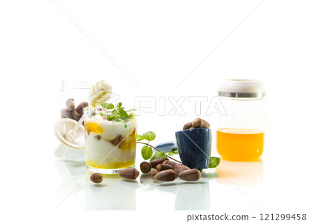 homemade yogurt with kiwi, honey and nuts in a glass, isolated on white background homemade yogurt with kiwi, honey and nuts in a glass, isolated on white background 121299458